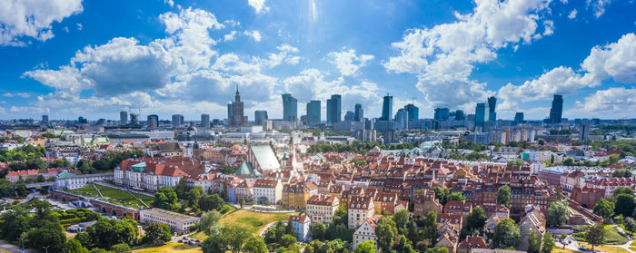 Aerial panorama of warsaw, poland over the vistula river and city center in a distance. sky clouds 