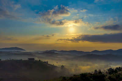 Scenic view of mountains against orange sky