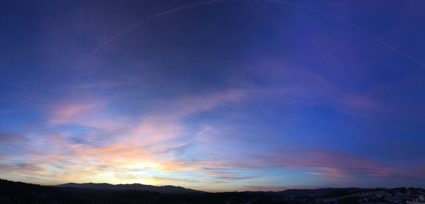 Low angle view of silhouette mountain against sky at sunset