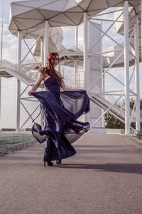 Young woman with umbrella on bridge