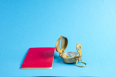 High angle view of coins on table against blue background