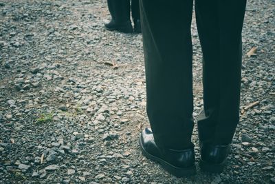 Low section of man standing on street