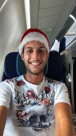 Portrait of smiling man sitting in airplane