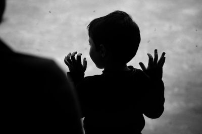 High angle view of boy looking through window