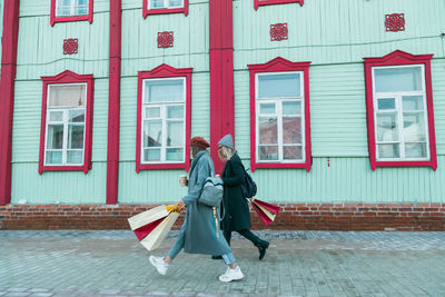 Low angle view of woman standing against built structures