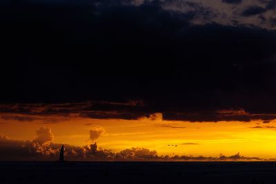 Scenic view of silhouette against sky at sunset