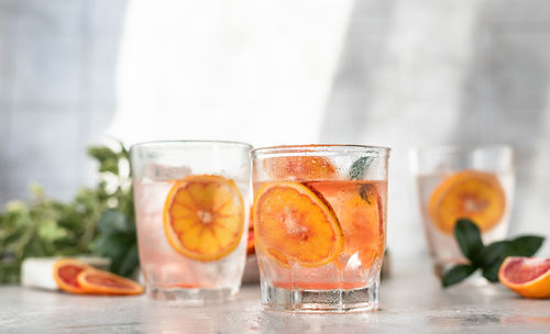 Cold refreshing drink with tonic, blood sicilian oranges and ice. cocktail with tonic and oranges.