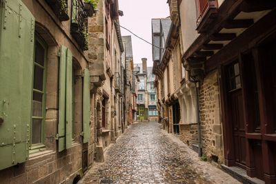 Alley amidst buildings against sky