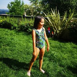 Full length of smiling woman standing on field