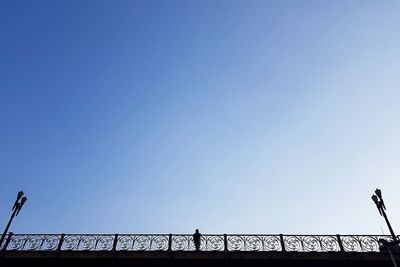 Low angle view of bridge against clear blue sky