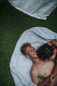 High angle view of man lying on grass