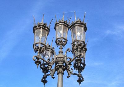 Low angle view of lamp against blue sky