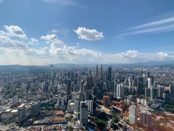 High angle view of modern buildings in city against sky