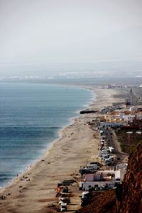 High angle view of sea and buildings against sky