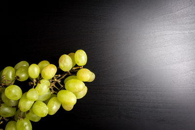 Close-up of grapes over black background