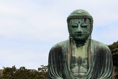 Statue of buddha against sky