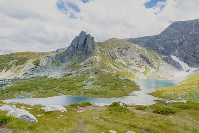 Scenic view of lake and mountains against sky