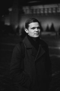Young man looking away in city