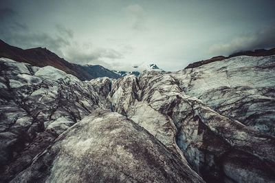 Scenic view of mountains against cloudy sky