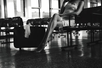 Low section of woman sitting on seat