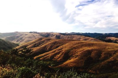 Scenic view of mountains against cloudy sky