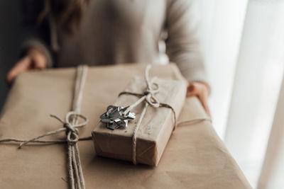 Midsection of woman holding gifts outdoors