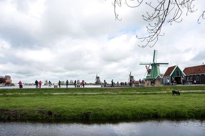 Group of people in front of buildings against sky