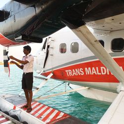 Full length of man standing on airplane