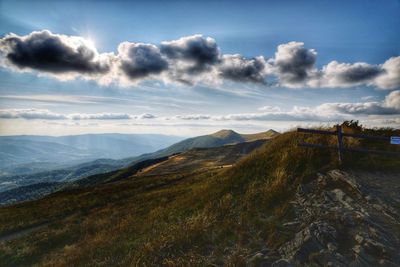 Scenic view of mountains against cloudy sky