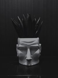 Digital composite image of drinking glass on table against black background