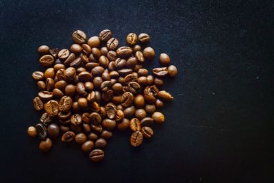 High angle view of coffee beans against black background