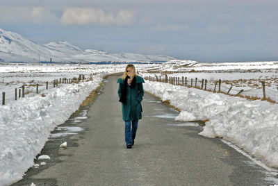 Woman walking on road during winter