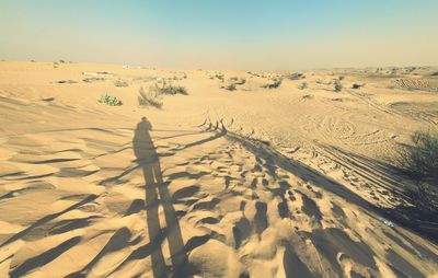 Scenic view of desert against clear sky during winter