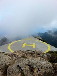 High angle view of helipad on mountain during foggy weather