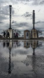 Built structure in sea against cloudy sky
