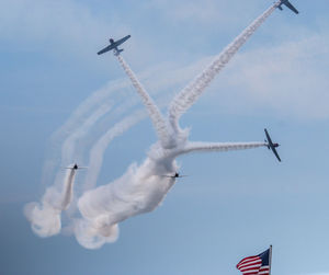 Low angle view of airplane flying against sky