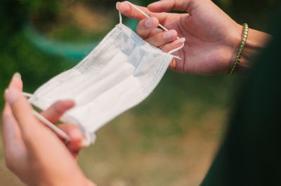 Midsection of woman holding paper