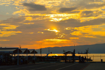 Silhouette city against sky during sunset