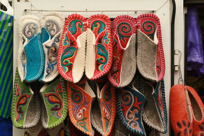 Multi colored shoe hanging at market stall