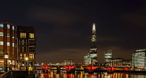 Low angle view of city lit up at night