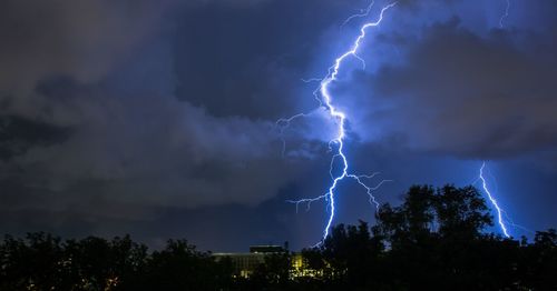 Low angle view of lightning in sky at night