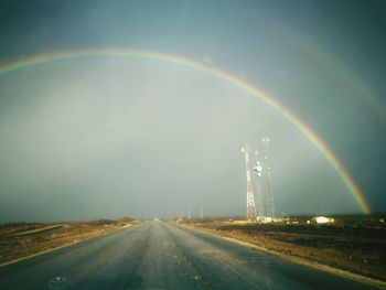 Rainbow over road in city