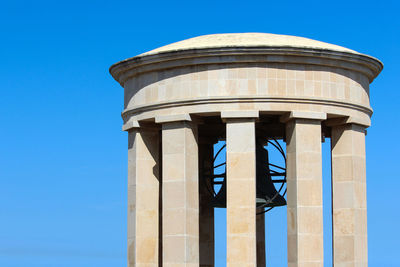 Low angle view of water tower against blue sky