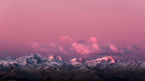 Scenic view of snowcapped mountains against sky during sunset