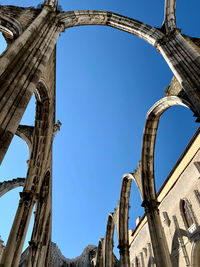 Low angle view of old building against blue sky