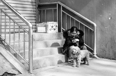 Dog and woman on staircase