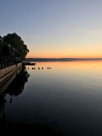 Scenic view of lake against sky during sunset