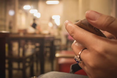 Close-up of woman hand holding cigarette