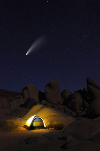 Scenic view of illuminated rock against sky at night