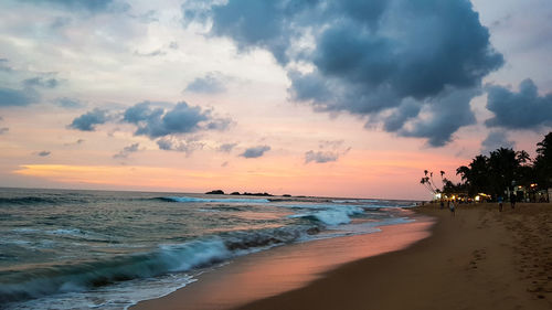 Scenic view of beach against sky during sunset